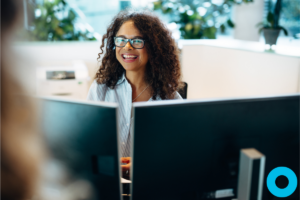 Smiling office manager for a dental office using software